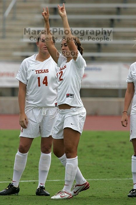 Alisha Ortiz,Women's Soccer #12,Forward, greets the crowd.  The University of Texas women's soccer team won 2-1 against the Iowa State Cyclones Sunday afternoon, October 5, 2008.

Filename: SRM_20081005_11534644.jpg
Aperture: f/8.0
Shutter Speed: 1/1000
Body: Canon EOS-1D Mark II
Lens: Canon EF 300mm f/2.8 L IS