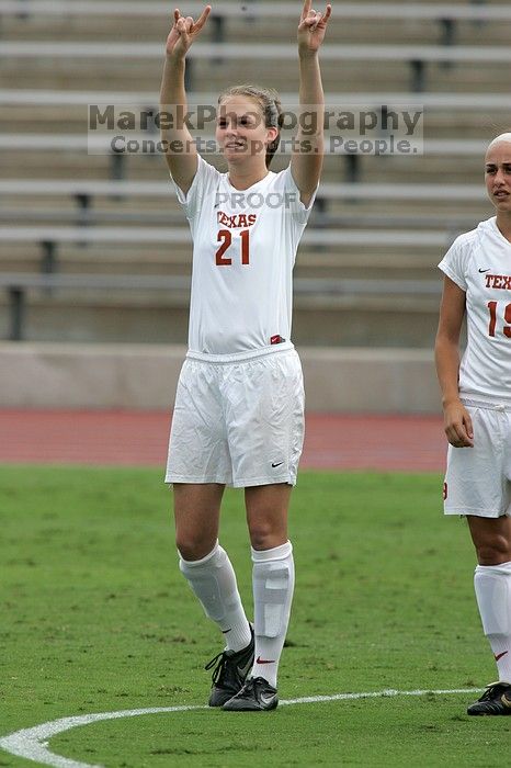 UT junior Emily Anderson (#21, Forward) greets the crowd.  The University of Texas women's soccer team won 2-1 against the Iowa State Cyclones Sunday afternoon, October 5, 2008.

Filename: SRM_20081005_11542450.jpg
Aperture: f/8.0
Shutter Speed: 1/1000
Body: Canon EOS-1D Mark II
Lens: Canon EF 300mm f/2.8 L IS