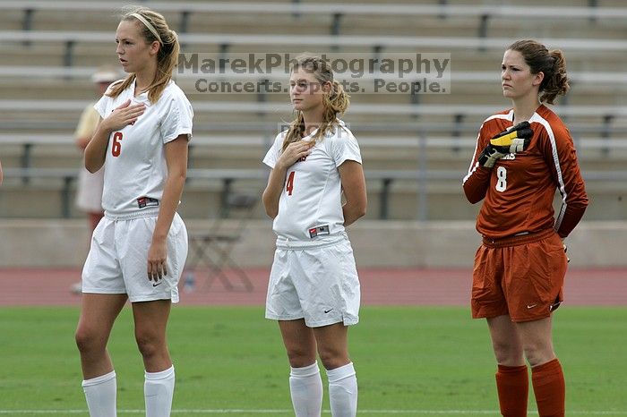 UT freshman Lucy Keith (#6, Midfielder), UT senior Jill Gilbeau (#4, Defender and Midfielder), and UT senior Dianna Pfenninger (#8, Goalkeeper) listen to the national anthem before the start of the game.  The University of Texas women's soccer team won 2-1 against the Iowa State Cyclones Sunday afternoon, October 5, 2008.

Filename: SRM_20081005_11552654.jpg
Aperture: f/8.0
Shutter Speed: 1/800
Body: Canon EOS-1D Mark II
Lens: Canon EF 300mm f/2.8 L IS