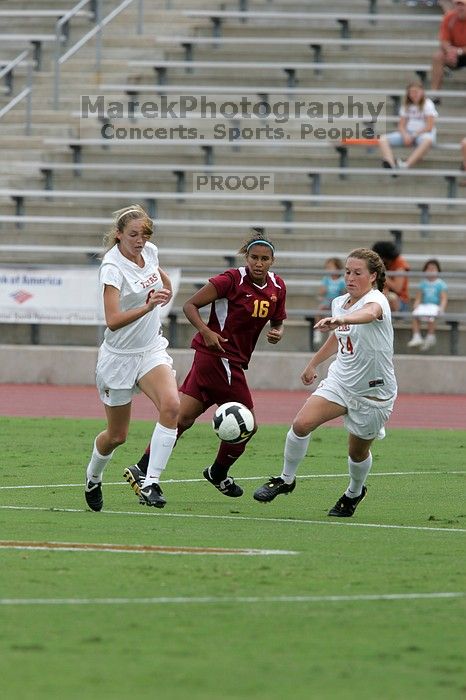 UT freshman Lucy Keith (#6, Midfielder) and UT senior Kasey Moore (#14, Defender) rush to the ball.  The University of Texas women's soccer team won 2-1 against the Iowa State Cyclones Sunday afternoon, October 5, 2008.

Filename: SRM_20081005_12022809.jpg
Aperture: f/5.6
Shutter Speed: 1/1250
Body: Canon EOS-1D Mark II
Lens: Canon EF 300mm f/2.8 L IS