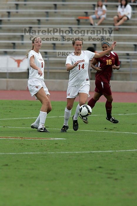 UT freshman Lucy Keith (#6, Midfielder) and UT senior Kasey Moore (#14, Defender) rush to the ball.  The University of Texas women's soccer team won 2-1 against the Iowa State Cyclones Sunday afternoon, October 5, 2008.

Filename: SRM_20081005_12023013.jpg
Aperture: f/5.6
Shutter Speed: 1/1600
Body: Canon EOS-1D Mark II
Lens: Canon EF 300mm f/2.8 L IS