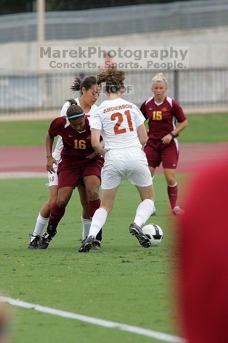 UT senior Stephanie Logterman (#10, Defender) and UT junior Emily Anderson (#21, Forward) team up on Iowa State #16.  The University of Texas women's soccer team won 2-1 against the Iowa State Cyclones Sunday afternoon, October 5, 2008.

Filename: SRM_20081005_12040225.jpg
Aperture: f/5.6
Shutter Speed: 1/1250
Body: Canon EOS-1D Mark II
Lens: Canon EF 300mm f/2.8 L IS