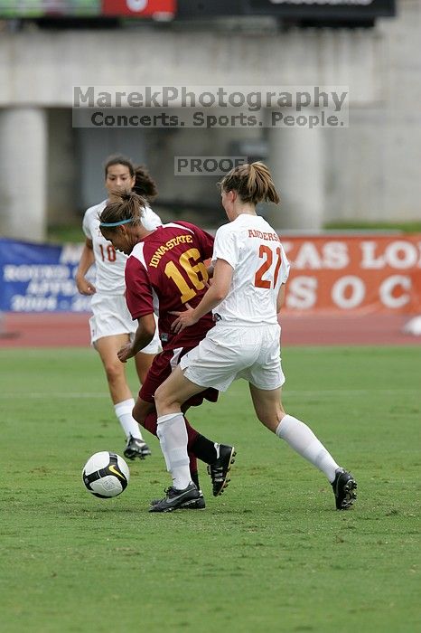 UT senior Stephanie Logterman (#10, Defender) and UT junior Emily Anderson (#21, Forward) team up on Iowa State #16.  The University of Texas women's soccer team won 2-1 against the Iowa State Cyclones Sunday afternoon, October 5, 2008.

Filename: SRM_20081005_12051443.jpg
Aperture: f/5.6
Shutter Speed: 1/1250
Body: Canon EOS-1D Mark II
Lens: Canon EF 300mm f/2.8 L IS