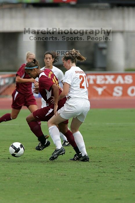 UT senior Stephanie Logterman (#10, Defender) and UT junior Emily Anderson (#21, Forward) team up on Iowa State #16.  The University of Texas women's soccer team won 2-1 against the Iowa State Cyclones Sunday afternoon, October 5, 2008.

Filename: SRM_20081005_12051444.jpg
Aperture: f/5.6
Shutter Speed: 1/1600
Body: Canon EOS-1D Mark II
Lens: Canon EF 300mm f/2.8 L IS