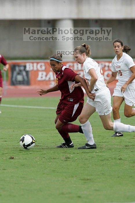 UT senior Stephanie Logterman (#10, Defender) and UT junior Emily Anderson (#21, Forward) team up on Iowa State #16.  The University of Texas women's soccer team won 2-1 against the Iowa State Cyclones Sunday afternoon, October 5, 2008.

Filename: SRM_20081005_12051445.jpg
Aperture: f/5.6
Shutter Speed: 1/1250
Body: Canon EOS-1D Mark II
Lens: Canon EF 300mm f/2.8 L IS