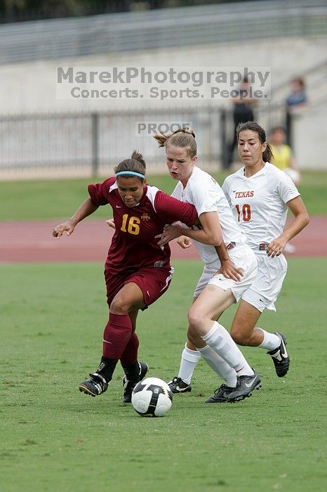 UT senior Stephanie Logterman (#10, Defender) and UT junior Emily Anderson (#21, Forward) team up on Iowa State #16.  The University of Texas women's soccer team won 2-1 against the Iowa State Cyclones Sunday afternoon, October 5, 2008.

Filename: SRM_20081005_12051852.jpg
Aperture: f/5.6
Shutter Speed: 1/1250
Body: Canon EOS-1D Mark II
Lens: Canon EF 300mm f/2.8 L IS