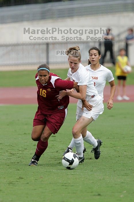 UT senior Stephanie Logterman (#10, Defender) and UT junior Emily Anderson (#21, Forward) team up on Iowa State #16.  The University of Texas women's soccer team won 2-1 against the Iowa State Cyclones Sunday afternoon, October 5, 2008.

Filename: SRM_20081005_12051853.jpg
Aperture: f/5.6
Shutter Speed: 1/1250
Body: Canon EOS-1D Mark II
Lens: Canon EF 300mm f/2.8 L IS