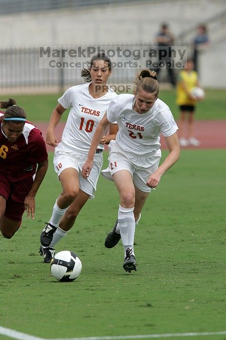 UT senior Stephanie Logterman (#10, Defender) and UT junior Emily Anderson (#21, Forward) team up on Iowa State #16.  The University of Texas women's soccer team won 2-1 against the Iowa State Cyclones Sunday afternoon, October 5, 2008.

Filename: SRM_20081005_12052056.jpg
Aperture: f/5.6
Shutter Speed: 1/1600
Body: Canon EOS-1D Mark II
Lens: Canon EF 300mm f/2.8 L IS