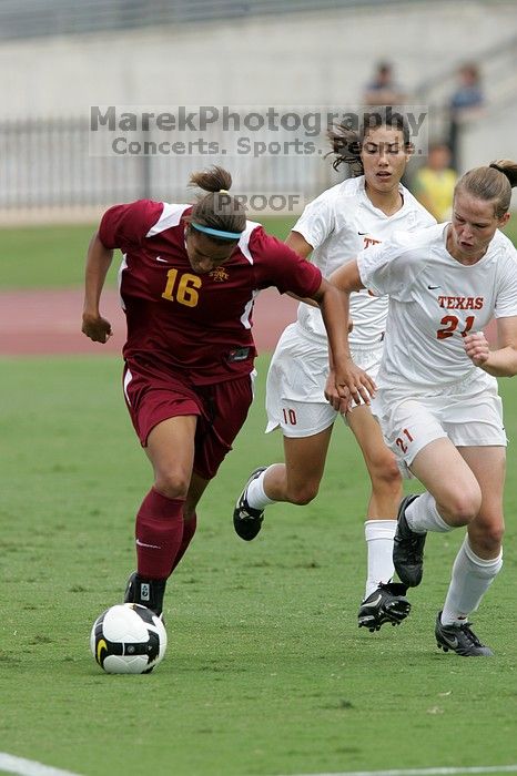 UT senior Stephanie Logterman (#10, Defender) and UT junior Emily Anderson (#21, Forward) team up on Iowa State #16.  The University of Texas women's soccer team won 2-1 against the Iowa State Cyclones Sunday afternoon, October 5, 2008.

Filename: SRM_20081005_12052057.jpg
Aperture: f/5.6
Shutter Speed: 1/1250
Body: Canon EOS-1D Mark II
Lens: Canon EF 300mm f/2.8 L IS