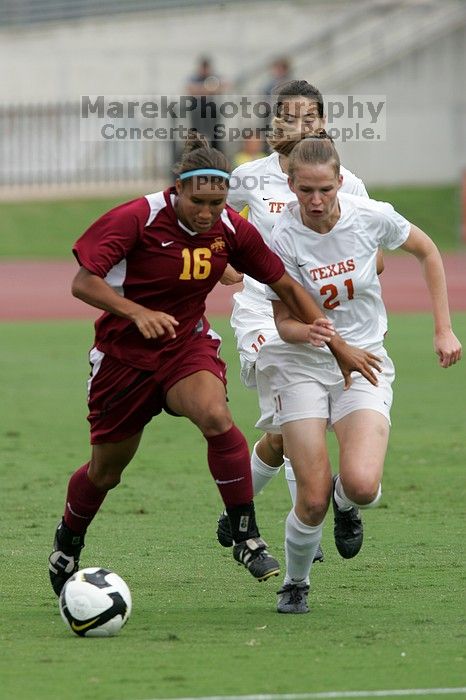 UT senior Stephanie Logterman (#10, Defender) and UT junior Emily Anderson (#21, Forward) team up on Iowa State #16.  The University of Texas women's soccer team won 2-1 against the Iowa State Cyclones Sunday afternoon, October 5, 2008.

Filename: SRM_20081005_12052059.jpg
Aperture: f/5.6
Shutter Speed: 1/1250
Body: Canon EOS-1D Mark II
Lens: Canon EF 300mm f/2.8 L IS