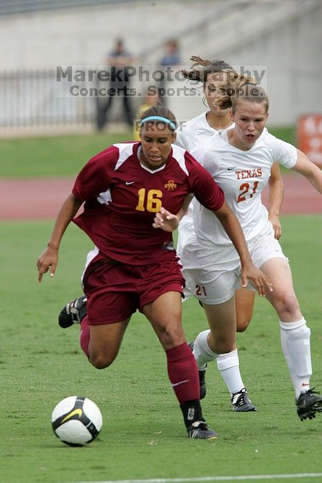 UT senior Stephanie Logterman (#10, Defender) and UT junior Emily Anderson (#21, Forward) team up on Iowa State #16.  The University of Texas women's soccer team won 2-1 against the Iowa State Cyclones Sunday afternoon, October 5, 2008.

Filename: SRM_20081005_12052060.jpg
Aperture: f/5.6
Shutter Speed: 1/1250
Body: Canon EOS-1D Mark II
Lens: Canon EF 300mm f/2.8 L IS