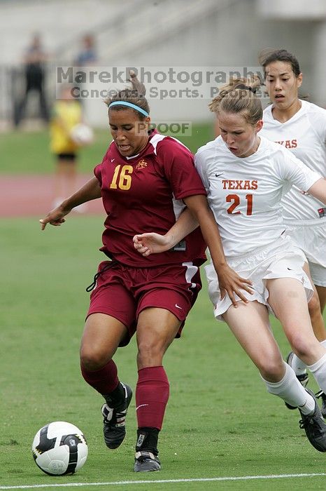 UT senior Stephanie Logterman (#10, Defender) and UT junior Emily Anderson (#21, Forward) team up on Iowa State #16.  The University of Texas women's soccer team won 2-1 against the Iowa State Cyclones Sunday afternoon, October 5, 2008.

Filename: SRM_20081005_12052262.jpg
Aperture: f/5.6
Shutter Speed: 1/1250
Body: Canon EOS-1D Mark II
Lens: Canon EF 300mm f/2.8 L IS