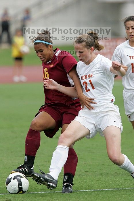 UT senior Stephanie Logterman (#10, Defender) and UT junior Emily Anderson (#21, Forward) team up on Iowa State #16.  The University of Texas women's soccer team won 2-1 against the Iowa State Cyclones Sunday afternoon, October 5, 2008.

Filename: SRM_20081005_12052264.jpg
Aperture: f/5.6
Shutter Speed: 1/1250
Body: Canon EOS-1D Mark II
Lens: Canon EF 300mm f/2.8 L IS