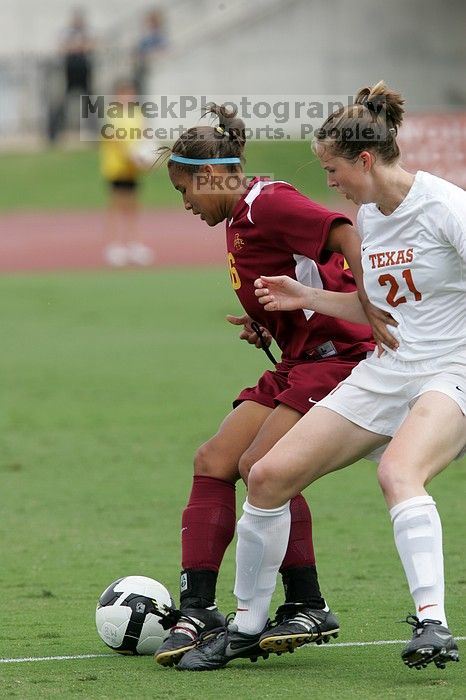 UT senior Stephanie Logterman (#10, Defender) and UT junior Emily Anderson (#21, Forward) team up on Iowa State #16.  The University of Texas women's soccer team won 2-1 against the Iowa State Cyclones Sunday afternoon, October 5, 2008.

Filename: SRM_20081005_12052266.jpg
Aperture: f/5.6
Shutter Speed: 1/1250
Body: Canon EOS-1D Mark II
Lens: Canon EF 300mm f/2.8 L IS