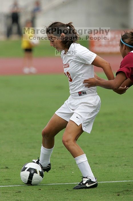 UT senior Stephanie Logterman (#10, Defender) and UT junior Emily Anderson (#21, Forward) team up on Iowa State #16.  The University of Texas women's soccer team won 2-1 against the Iowa State Cyclones Sunday afternoon, October 5, 2008.

Filename: SRM_20081005_12052468.jpg
Aperture: f/5.6
Shutter Speed: 1/1600
Body: Canon EOS-1D Mark II
Lens: Canon EF 300mm f/2.8 L IS