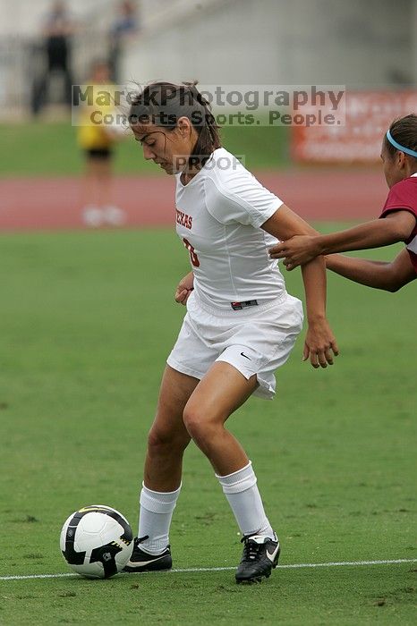 UT senior Stephanie Logterman (#10, Defender) and UT junior Emily Anderson (#21, Forward) team up on Iowa State #16.  The University of Texas women's soccer team won 2-1 against the Iowa State Cyclones Sunday afternoon, October 5, 2008.

Filename: SRM_20081005_12052469.jpg
Aperture: f/5.6
Shutter Speed: 1/1600
Body: Canon EOS-1D Mark II
Lens: Canon EF 300mm f/2.8 L IS