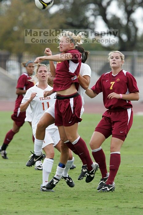 UT senior Stephanie Logterman (#10, Defender) fights for the header with Iowa State #18 as UT sophomore Niki Arlitt (#11, Forward) watches.  The University of Texas women's soccer team won 2-1 against the Iowa State Cyclones Sunday afternoon, October 5, 2008.

Filename: SRM_20081005_12181847.jpg
Aperture: f/5.6
Shutter Speed: 1/800
Body: Canon EOS-1D Mark II
Lens: Canon EF 300mm f/2.8 L IS