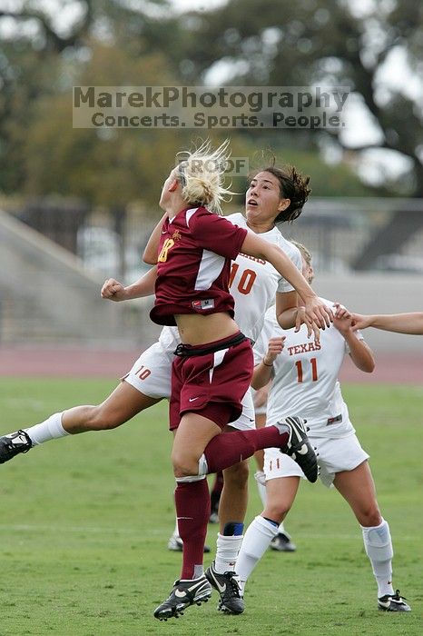 UT senior Stephanie Logterman (#10, Defender) fights for the header with Iowa State #18 as UT sophomore Niki Arlitt (#11, Forward) watches.  The University of Texas women's soccer team won 2-1 against the Iowa State Cyclones Sunday afternoon, October 5, 2008.

Filename: SRM_20081005_12182049.jpg
Aperture: f/5.6
Shutter Speed: 1/1000
Body: Canon EOS-1D Mark II
Lens: Canon EF 300mm f/2.8 L IS