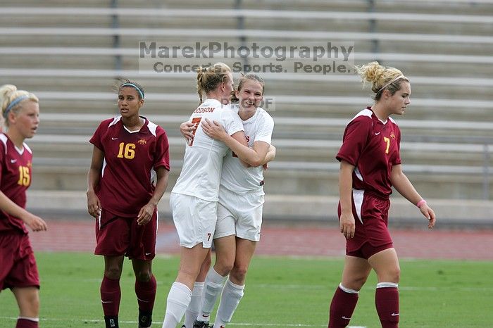 UT freshman Courtney Goodson (#7, Forward and Midfielder) congratulates UT junior Emily Anderson (#21, Forward) after her goal in the first half.  The University of Texas women's soccer team won 2-1 against the Iowa State Cyclones Sunday afternoon, October 5, 2008.

Filename: SRM_20081005_12210694.jpg
Aperture: f/5.0
Shutter Speed: 1/1600
Body: Canon EOS-1D Mark II
Lens: Canon EF 300mm f/2.8 L IS