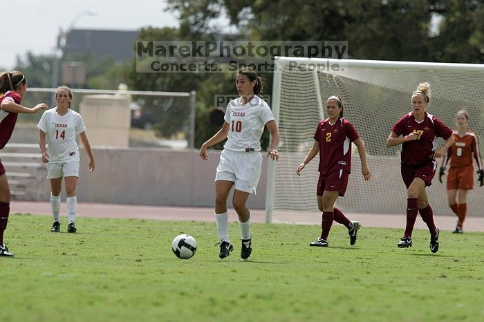 UT senior Stephanie Logterman (#10, Defender) passes the ball to UT sophomore Niki Arlitt (#11, Forward).  The University of Texas women's soccer team won 2-1 against the Iowa State Cyclones Sunday afternoon, October 5, 2008.

Filename: SRM_20081005_12303487.jpg
Aperture: f/5.6
Shutter Speed: 1/2500
Body: Canon EOS-1D Mark II
Lens: Canon EF 300mm f/2.8 L IS