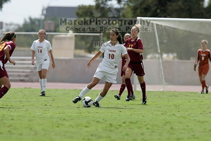 UT senior Stephanie Logterman (#10, Defender) passes the ball to UT sophomore Niki Arlitt (#11, Forward).  The University of Texas women's soccer team won 2-1 against the Iowa State Cyclones Sunday afternoon, October 5, 2008.

Filename: SRM_20081005_12303690.jpg
Aperture: f/5.6
Shutter Speed: 1/2000
Body: Canon EOS-1D Mark II
Lens: Canon EF 300mm f/2.8 L IS