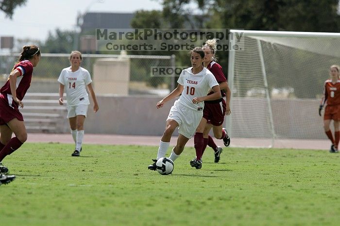 UT senior Stephanie Logterman (#10, Defender) passes the ball to UT sophomore Niki Arlitt (#11, Forward).  The University of Texas women's soccer team won 2-1 against the Iowa State Cyclones Sunday afternoon, October 5, 2008.

Filename: SRM_20081005_12303691.jpg
Aperture: f/5.6
Shutter Speed: 1/2500
Body: Canon EOS-1D Mark II
Lens: Canon EF 300mm f/2.8 L IS