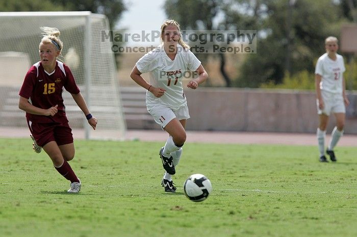 UT senior Stephanie Logterman (#10, Defender) passes the ball to UT sophomore Niki Arlitt (#11, Forward).  The University of Texas women's soccer team won 2-1 against the Iowa State Cyclones Sunday afternoon, October 5, 2008.

Filename: SRM_20081005_12303896.jpg
Aperture: f/5.6
Shutter Speed: 1/2000
Body: Canon EOS-1D Mark II
Lens: Canon EF 300mm f/2.8 L IS