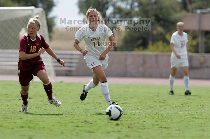 UT senior Stephanie Logterman (#10, Defender) passes the ball to UT sophomore Niki Arlitt (#11, Forward).  The University of Texas women's soccer team won 2-1 against the Iowa State Cyclones Sunday afternoon, October 5, 2008.

Filename: SRM_20081005_12303897.jpg
Aperture: f/5.6
Shutter Speed: 1/2000
Body: Canon EOS-1D Mark II
Lens: Canon EF 300mm f/2.8 L IS