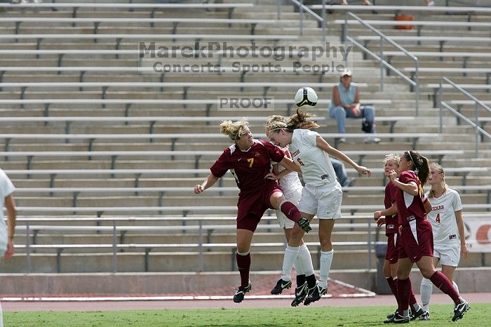 UT freshman Lucy Keith (#6, Midfielder) fights for the header as UT senior Jill Gilbeau (#4, Defender and Midfielder) watches.  The University of Texas women's soccer team won 2-1 against the Iowa State Cyclones Sunday afternoon, October 5, 2008.

Filename: SRM_20081005_12313699.jpg
Aperture: f/5.6
Shutter Speed: 1/2000
Body: Canon EOS-1D Mark II
Lens: Canon EF 300mm f/2.8 L IS