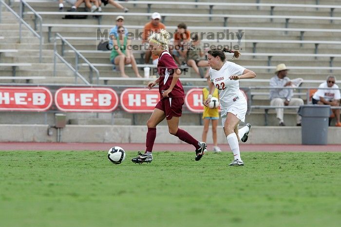 UT junior Stephanie Gibson (#22, Defense and Forward) steals the ball from an Iowa State player.  The University of Texas women's soccer team won 2-1 against the Iowa State Cyclones Sunday afternoon, October 5, 2008.

Filename: SRM_20081005_12354844.jpg
Aperture: f/5.6
Shutter Speed: 1/1000
Body: Canon EOS-1D Mark II
Lens: Canon EF 300mm f/2.8 L IS