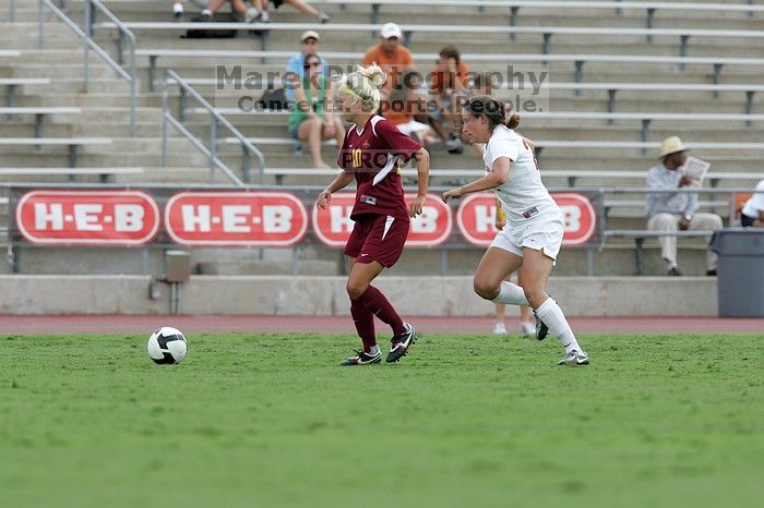 UT junior Stephanie Gibson (#22, Defense and Forward) steals the ball from an Iowa State player.  The University of Texas women's soccer team won 2-1 against the Iowa State Cyclones Sunday afternoon, October 5, 2008.

Filename: SRM_20081005_12354845.jpg
Aperture: f/5.6
Shutter Speed: 1/1000
Body: Canon EOS-1D Mark II
Lens: Canon EF 300mm f/2.8 L IS