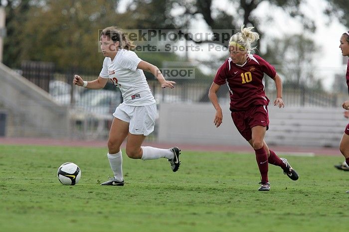 UT junior Stephanie Gibson (#22, Defense and Forward) steals the ball from an Iowa State player.  The University of Texas women's soccer team won 2-1 against the Iowa State Cyclones Sunday afternoon, October 5, 2008.

Filename: SRM_20081005_12364447.jpg
Aperture: f/5.6
Shutter Speed: 1/1000
Body: Canon EOS-1D Mark II
Lens: Canon EF 300mm f/2.8 L IS