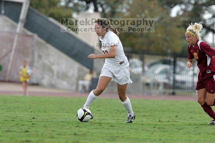 UT junior Stephanie Gibson (#22, Defense and Forward) steals the ball from an Iowa State player.  The University of Texas women's soccer team won 2-1 against the Iowa State Cyclones Sunday afternoon, October 5, 2008.

Filename: SRM_20081005_12364448.jpg
Aperture: f/5.6
Shutter Speed: 1/1000
Body: Canon EOS-1D Mark II
Lens: Canon EF 300mm f/2.8 L IS