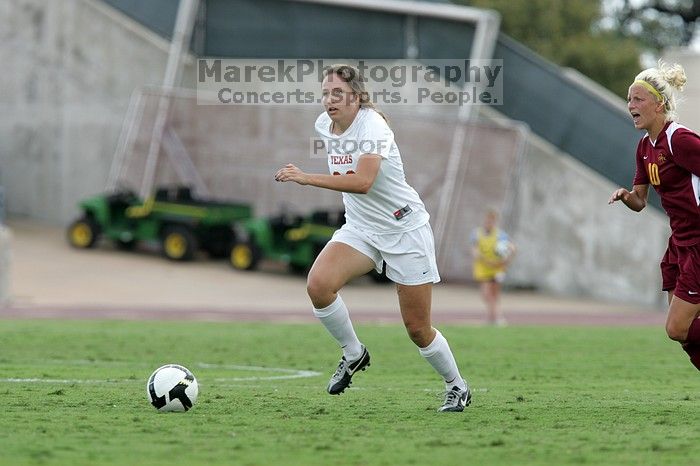 UT junior Stephanie Gibson (#22, Defense and Forward) steals the ball from an Iowa State player.  The University of Texas women's soccer team won 2-1 against the Iowa State Cyclones Sunday afternoon, October 5, 2008.

Filename: SRM_20081005_12364450.jpg
Aperture: f/5.6
Shutter Speed: 1/1000
Body: Canon EOS-1D Mark II
Lens: Canon EF 300mm f/2.8 L IS