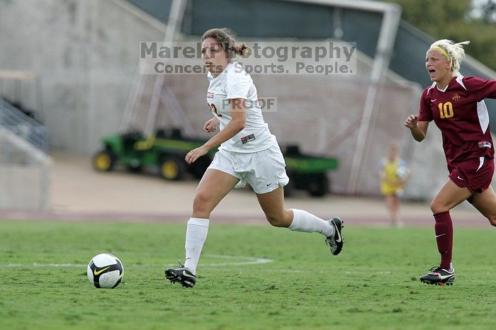 UT junior Stephanie Gibson (#22, Defense and Forward) steals the ball from an Iowa State player.  The University of Texas women's soccer team won 2-1 against the Iowa State Cyclones Sunday afternoon, October 5, 2008.

Filename: SRM_20081005_12364651.jpg
Aperture: f/5.6
Shutter Speed: 1/1000
Body: Canon EOS-1D Mark II
Lens: Canon EF 300mm f/2.8 L IS