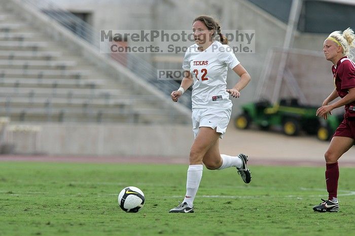 UT junior Stephanie Gibson (#22, Defense and Forward) steals the ball from an Iowa State player.  The University of Texas women's soccer team won 2-1 against the Iowa State Cyclones Sunday afternoon, October 5, 2008.

Filename: SRM_20081005_12364652.jpg
Aperture: f/5.6
Shutter Speed: 1/1250
Body: Canon EOS-1D Mark II
Lens: Canon EF 300mm f/2.8 L IS