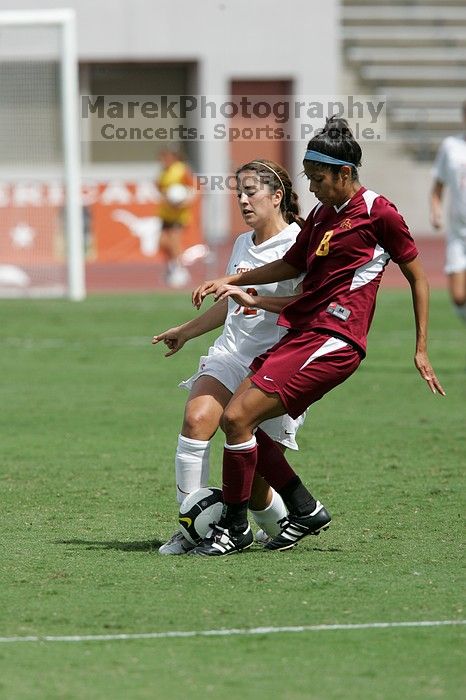 UT sophomore Alisha Ortiz (#12, Forward) withstands a tackle in the second half.  The University of Texas women's soccer team won 2-1 against the Iowa State Cyclones Sunday afternoon, October 5, 2008.

Filename: SRM_20081005_13135494.jpg
Aperture: f/5.6
Shutter Speed: 1/2000
Body: Canon EOS-1D Mark II
Lens: Canon EF 300mm f/2.8 L IS