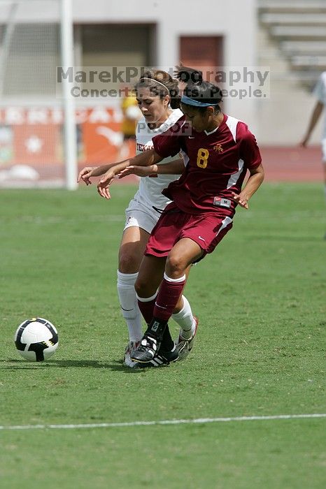 UT sophomore Alisha Ortiz (#12, Forward) withstands a tackle in the second half.  The University of Texas women's soccer team won 2-1 against the Iowa State Cyclones Sunday afternoon, October 5, 2008.

Filename: SRM_20081005_13135495.jpg
Aperture: f/5.6
Shutter Speed: 1/2000
Body: Canon EOS-1D Mark II
Lens: Canon EF 300mm f/2.8 L IS