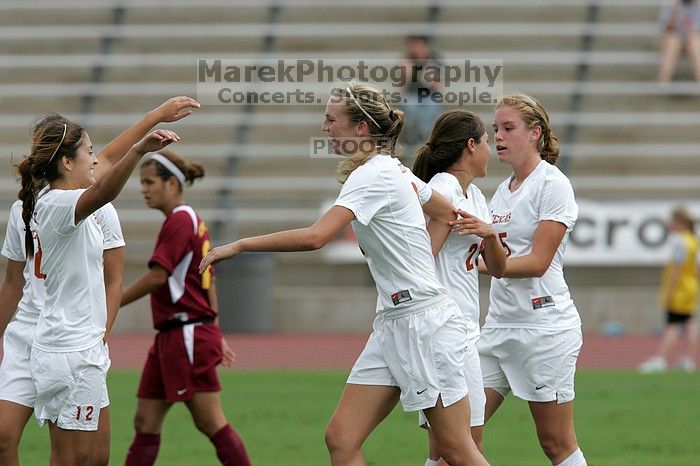 UT sophomore Alisha Ortiz (#12, Forward) congratulates UT freshman Lucy Keith (#6, Midfielder) on her goal in the second half.  The University of Texas women's soccer team won 2-1 against the Iowa State Cyclones Sunday afternoon, October 5, 2008.

Filename: SRM_20081005_13190213.jpg
Aperture: f/5.6
Shutter Speed: 1/1600
Body: Canon EOS-1D Mark II
Lens: Canon EF 300mm f/2.8 L IS