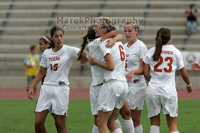 UT sophomore Alisha Ortiz (#12, Forward) congratulates UT freshman Lucy Keith (#6, Midfielder) on her goal in the second half.  The University of Texas women's soccer team won 2-1 against the Iowa State Cyclones Sunday afternoon, October 5, 2008.

Filename: SRM_20081005_13190418.jpg
Aperture: f/5.6
Shutter Speed: 1/2000
Body: Canon EOS-1D Mark II
Lens: Canon EF 300mm f/2.8 L IS