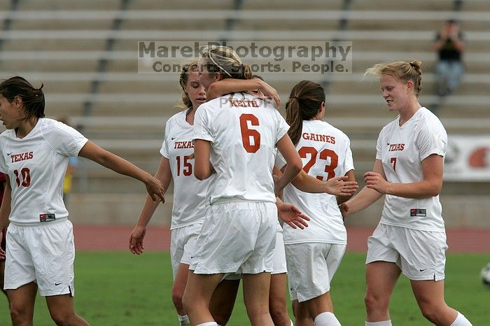 UT sophomore Alisha Ortiz (#12, Forward) congratulates UT freshman Lucy Keith (#6, Midfielder) on her goal in the second half.  The University of Texas women's soccer team won 2-1 against the Iowa State Cyclones Sunday afternoon, October 5, 2008.

Filename: SRM_20081005_13190621.jpg
Aperture: f/5.6
Shutter Speed: 1/2000
Body: Canon EOS-1D Mark II
Lens: Canon EF 300mm f/2.8 L IS