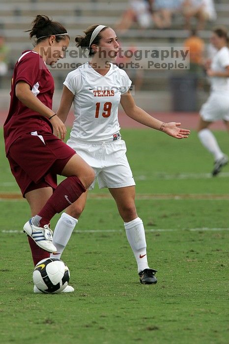 UT sophomore Erica Campanelli (#19, Defender) argues with a referee about a foul in the second half.  The University of Texas women's soccer team won 2-1 against the Iowa State Cyclones Sunday afternoon, October 5, 2008.

Filename: SRM_20081005_13312230.jpg
Aperture: f/5.6
Shutter Speed: 1/1600
Body: Canon EOS-1D Mark II
Lens: Canon EF 300mm f/2.8 L IS