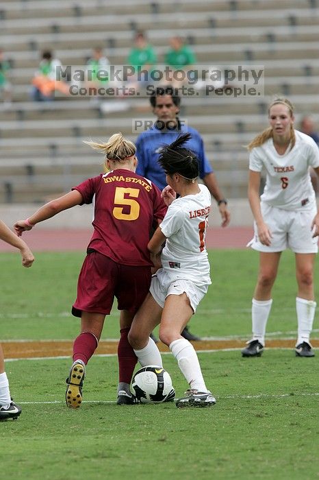 UT freshman Amanda Lisberger (#13, Midfielder) steals the ball as UT freshman Lucy Keith (#6, Midfielder) watches in the second half.  The University of Texas women's soccer team won 2-1 against the Iowa State Cyclones Sunday afternoon, October 5, 2008.

Filename: SRM_20081005_13335667.jpg
Aperture: f/5.6
Shutter Speed: 1/1250
Body: Canon EOS-1D Mark II
Lens: Canon EF 300mm f/2.8 L IS