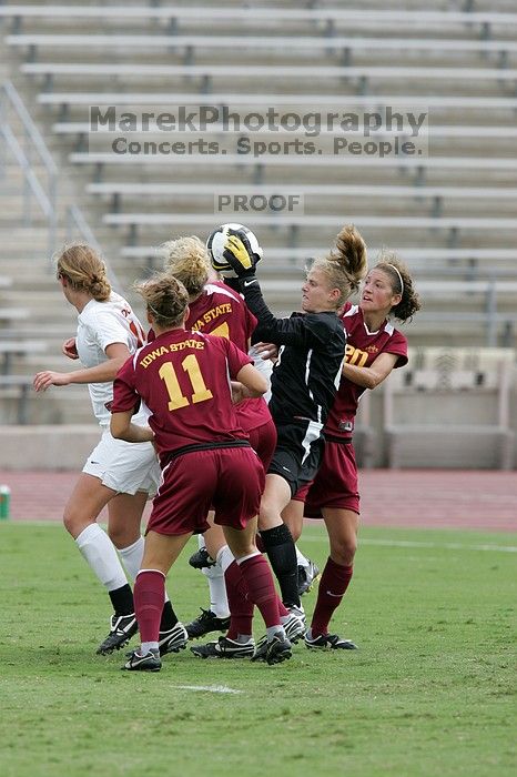 UT freshman Kylie Doniak (#15, Midfielder) and UT sophomore Kate Nicholson (#17, Forward and Midfielder) try for the header but the Iowa State goalkeeper gets to it first in the second half.  The University of Texas women's soccer team won 2-1 against the Iowa State Cyclones Sunday afternoon, October 5, 2008.

Filename: SRM_20081005_13403243.jpg
Aperture: f/5.6
Shutter Speed: 1/1250
Body: Canon EOS-1D Mark II
Lens: Canon EF 300mm f/2.8 L IS