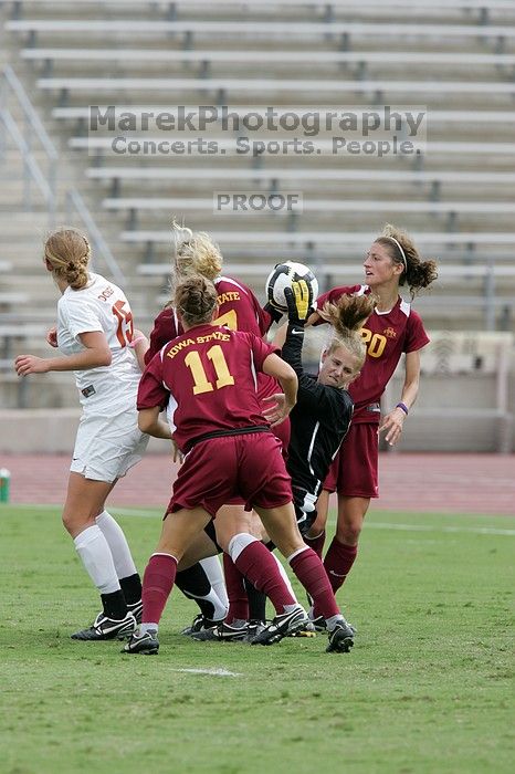 UT freshman Kylie Doniak (#15, Midfielder) and UT sophomore Kate Nicholson (#17, Forward and Midfielder) try for the header but the Iowa State goalkeeper gets to it first in the second half.  The University of Texas women's soccer team won 2-1 against the Iowa State Cyclones Sunday afternoon, October 5, 2008.

Filename: SRM_20081005_13403244.jpg
Aperture: f/5.6
Shutter Speed: 1/1000
Body: Canon EOS-1D Mark II
Lens: Canon EF 300mm f/2.8 L IS