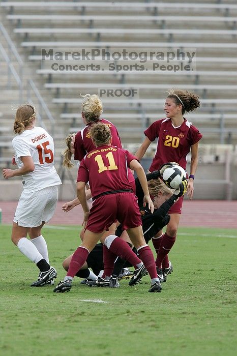 UT freshman Kylie Doniak (#15, Midfielder) and UT sophomore Kate Nicholson (#17, Forward and Midfielder) try for the header but the Iowa State goalkeeper gets to it first in the second half.  The University of Texas women's soccer team won 2-1 against the Iowa State Cyclones Sunday afternoon, October 5, 2008.

Filename: SRM_20081005_13403245.jpg
Aperture: f/5.6
Shutter Speed: 1/1250
Body: Canon EOS-1D Mark II
Lens: Canon EF 300mm f/2.8 L IS