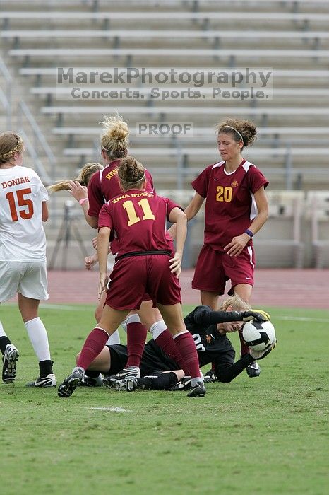 UT freshman Kylie Doniak (#15, Midfielder) and UT sophomore Kate Nicholson (#17, Forward and Midfielder) try for the header but the Iowa State goalkeeper gets to it first in the second half.  The University of Texas women's soccer team won 2-1 against the Iowa State Cyclones Sunday afternoon, October 5, 2008.

Filename: SRM_20081005_13403246.jpg
Aperture: f/5.6
Shutter Speed: 1/1250
Body: Canon EOS-1D Mark II
Lens: Canon EF 300mm f/2.8 L IS