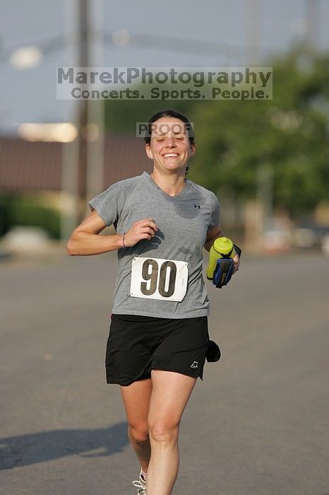 Beth Marek won first place in her age division at the Army Dillo half-marathon and 32K race.

Filename: SRM_20080921_0841386.jpg
Aperture: f/4.0
Shutter Speed: 1/2000
Body: Canon EOS-1D Mark II
Lens: Canon EF 300mm f/2.8 L IS