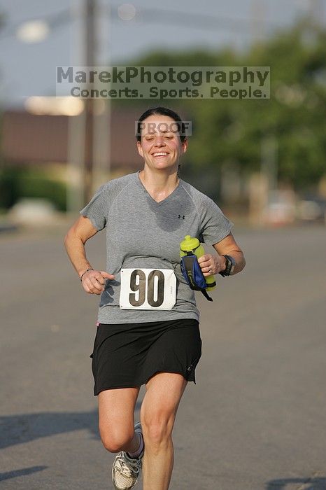 Beth Marek won first place in her age division at the Army Dillo half-marathon and 32K race.

Filename: SRM_20080921_0841387.jpg
Aperture: f/4.0
Shutter Speed: 1/2000
Body: Canon EOS-1D Mark II
Lens: Canon EF 300mm f/2.8 L IS