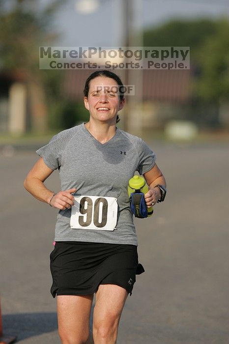 Beth Marek won first place in her age division at the Army Dillo half-marathon and 32K race.

Filename: SRM_20080921_0841401.jpg
Aperture: f/4.0
Shutter Speed: 1/2000
Body: Canon EOS-1D Mark II
Lens: Canon EF 300mm f/2.8 L IS